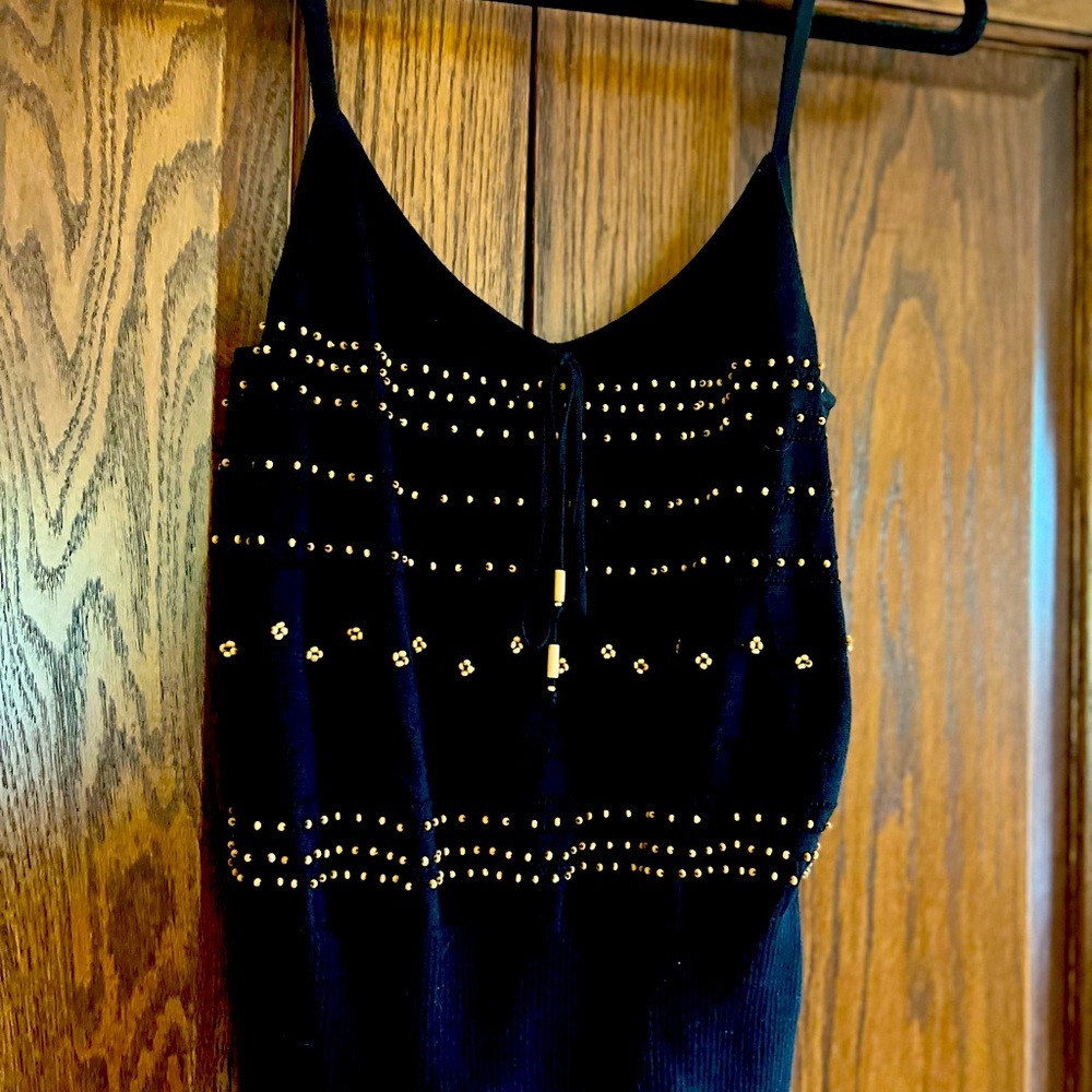 Sexy black tank with gold studs. Good condition.